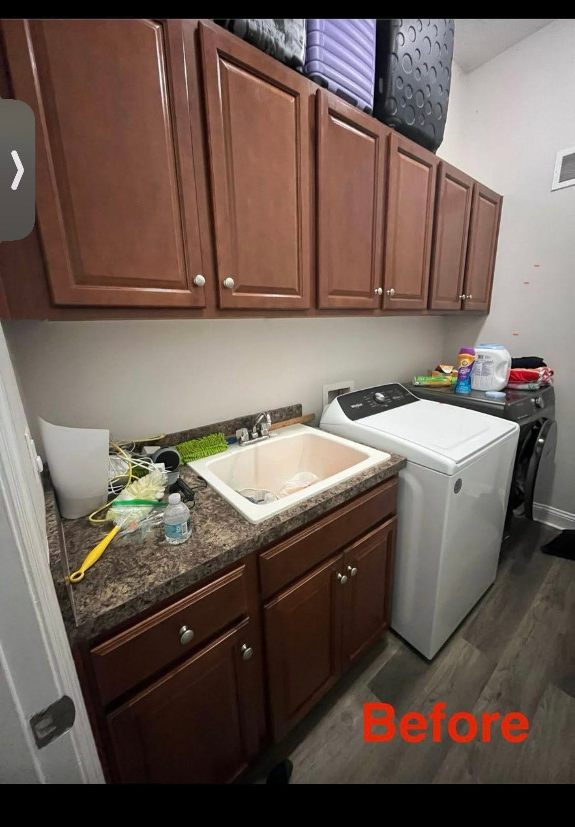 Laundry room with dark brown cabinets before being repainted