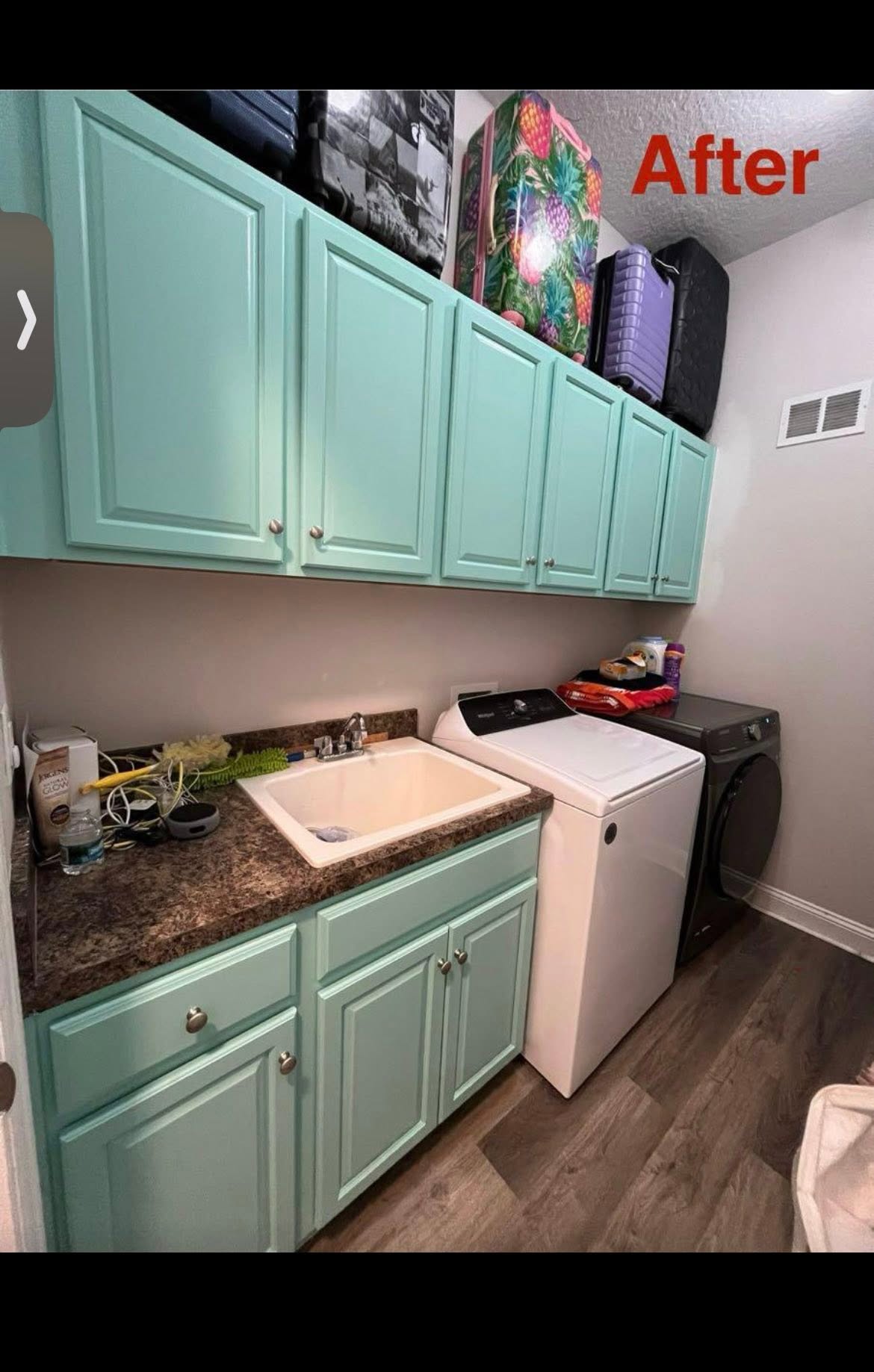 The same laundry room cabinets repainted in a soft mint green